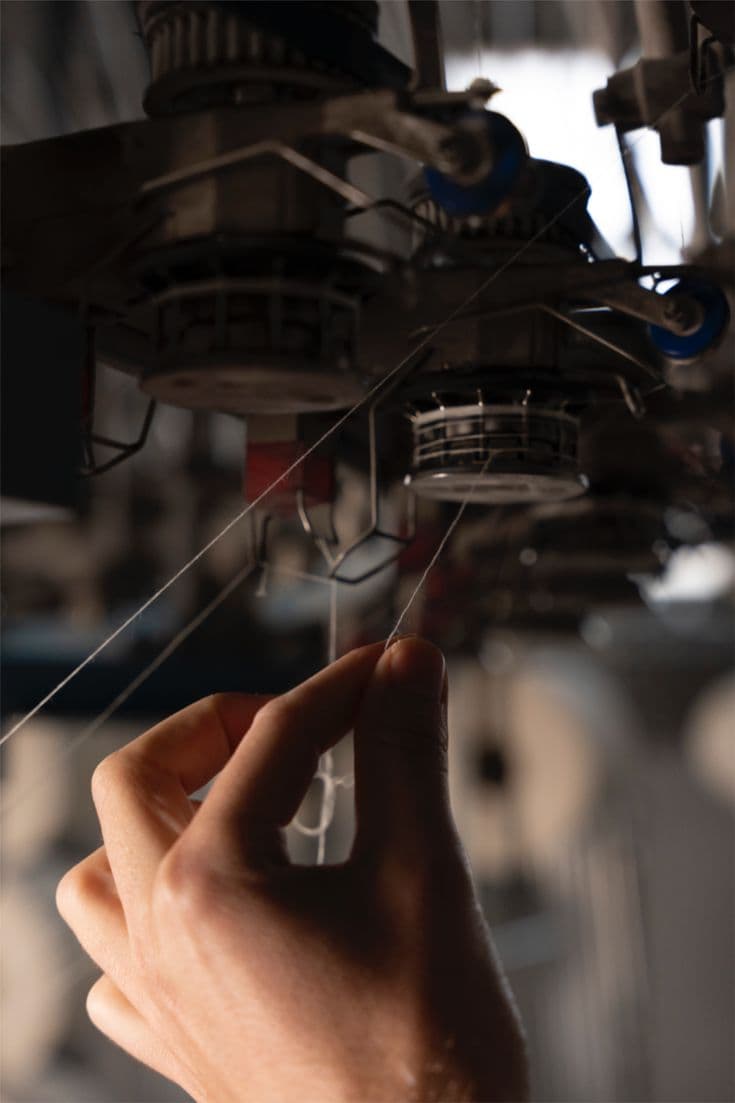 Hand threading yarn into a circular knitting machine