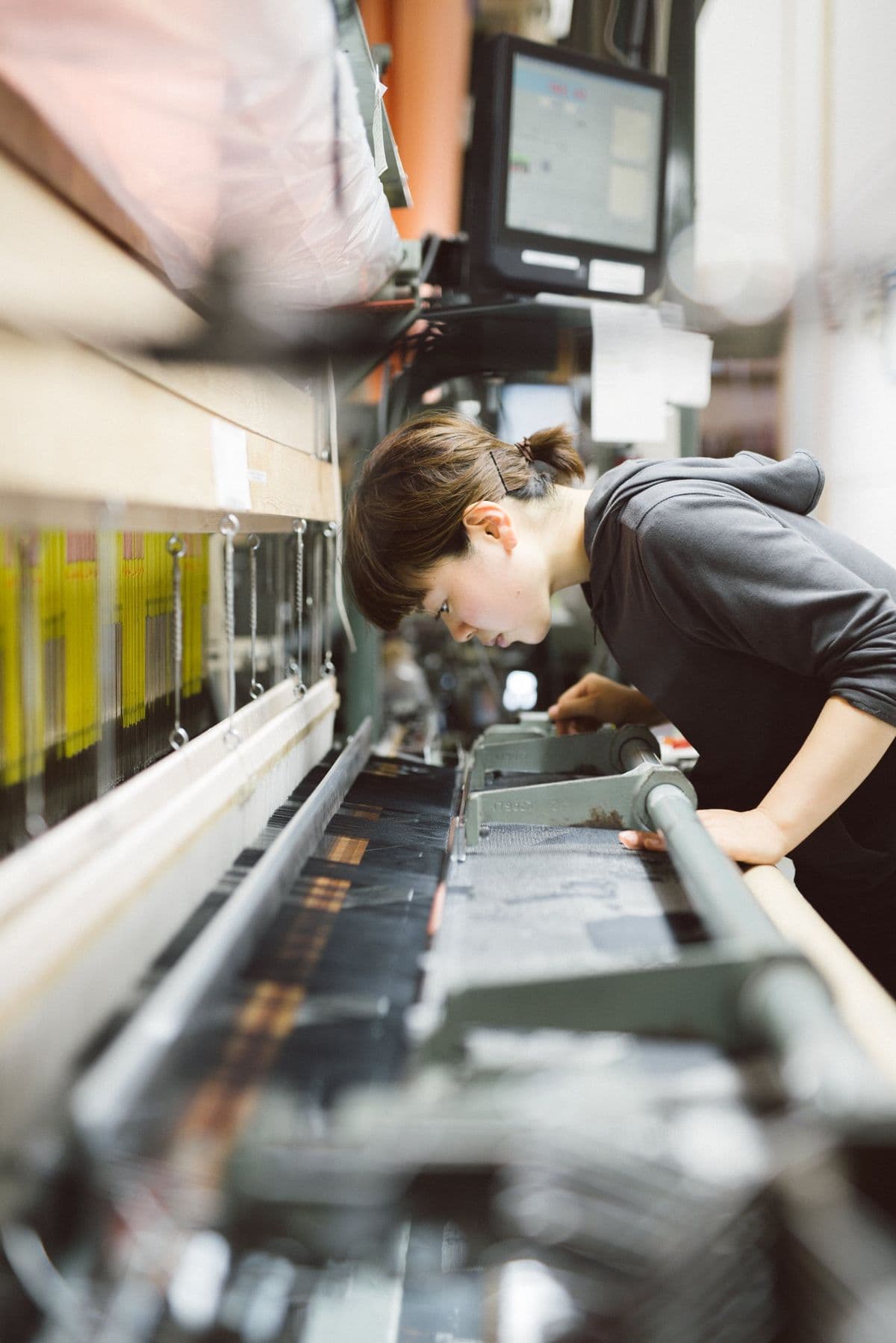 Technician adjusting a weaving loom