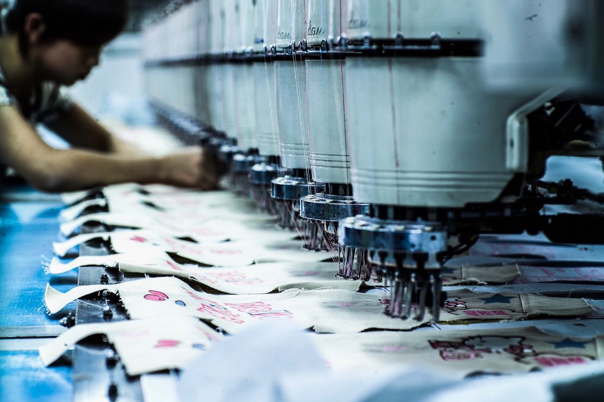 Multi-head embroidery machine running placement embroidery on panels
