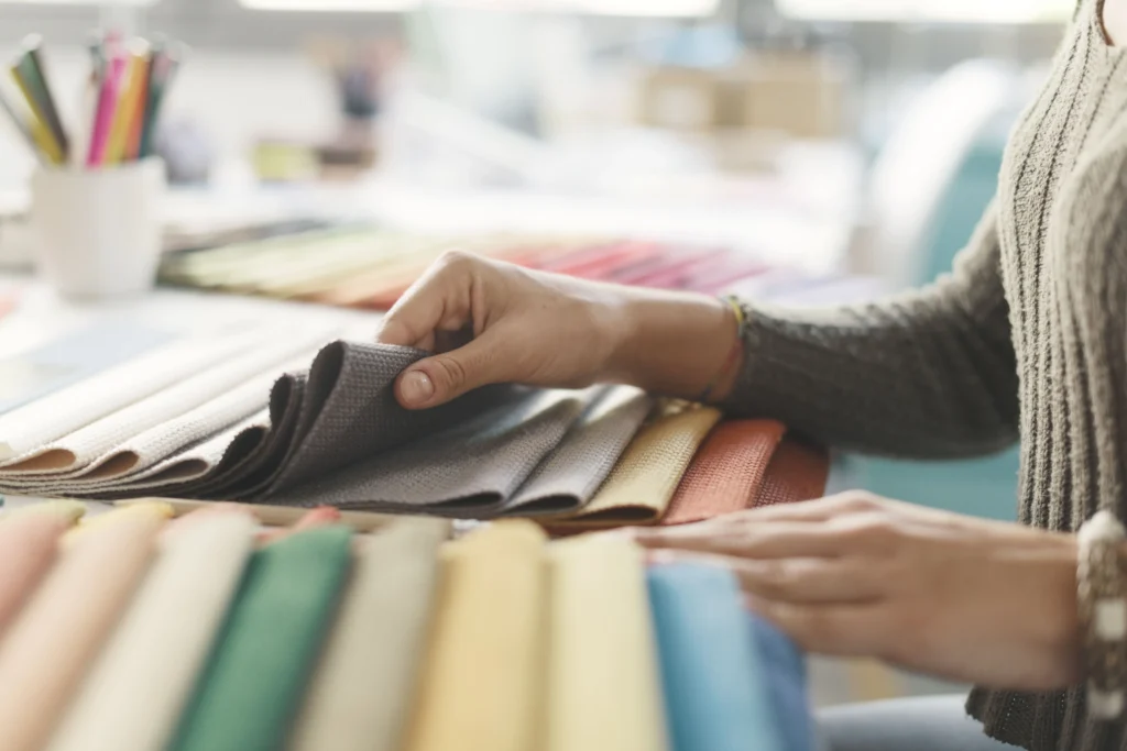 Selecting from a fan of coloured fabric swatches